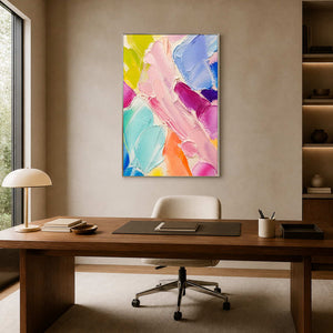 Colorful textured abstract wall art displayed in a warm creative office.