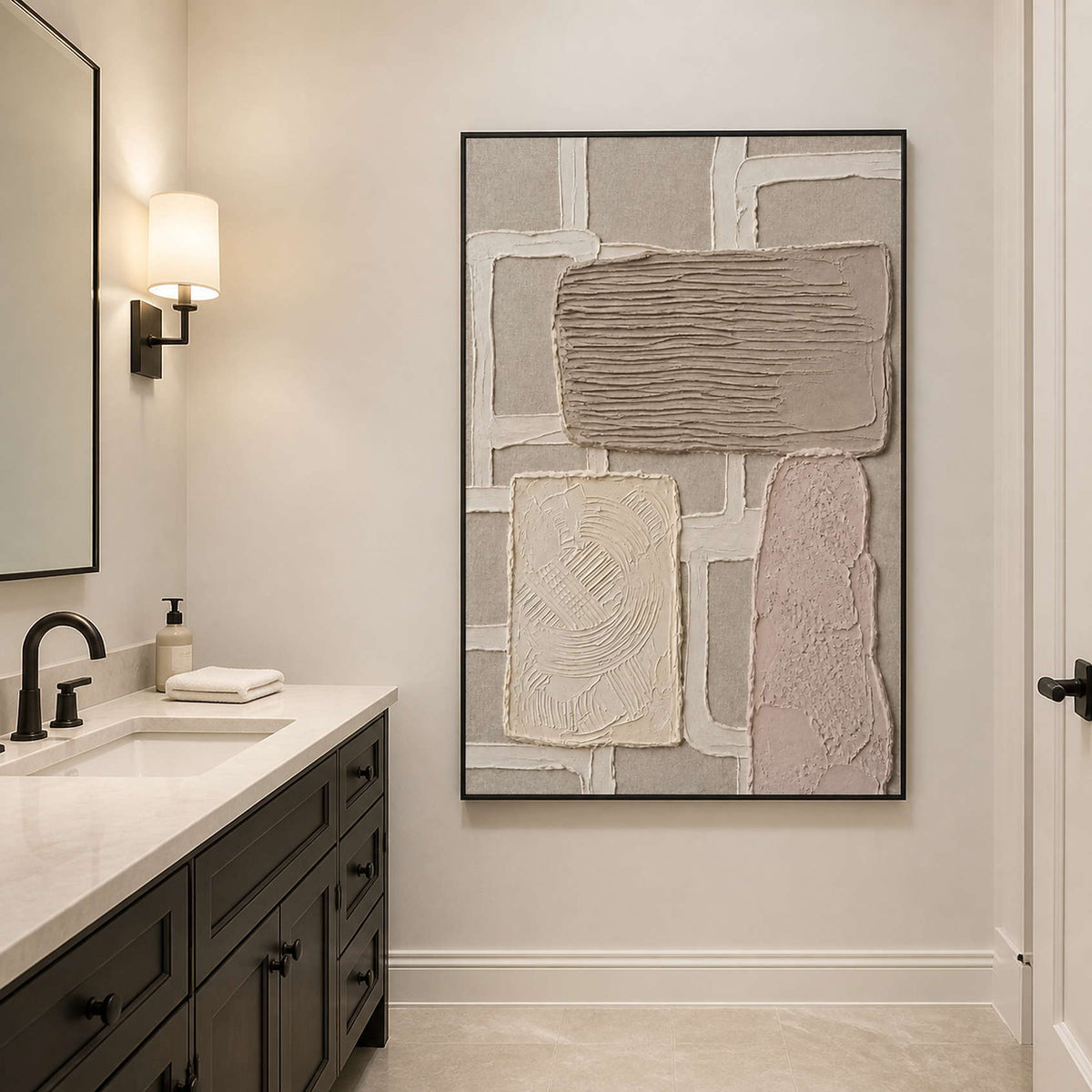 Neutral abstract wall art in a black frame beside a bathroom vanity.