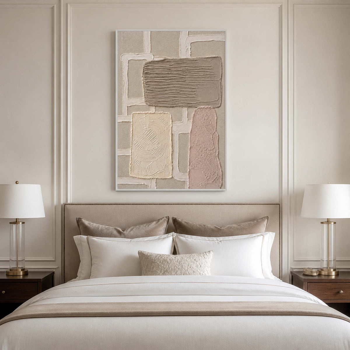 Soft neutral textured canvas in a white frame above a bedroom bed.