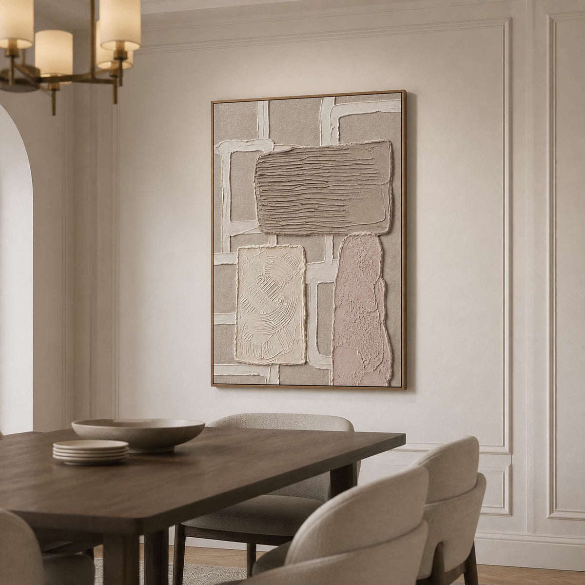 Taupe abstract wall art in a wood frame beside a dining table.