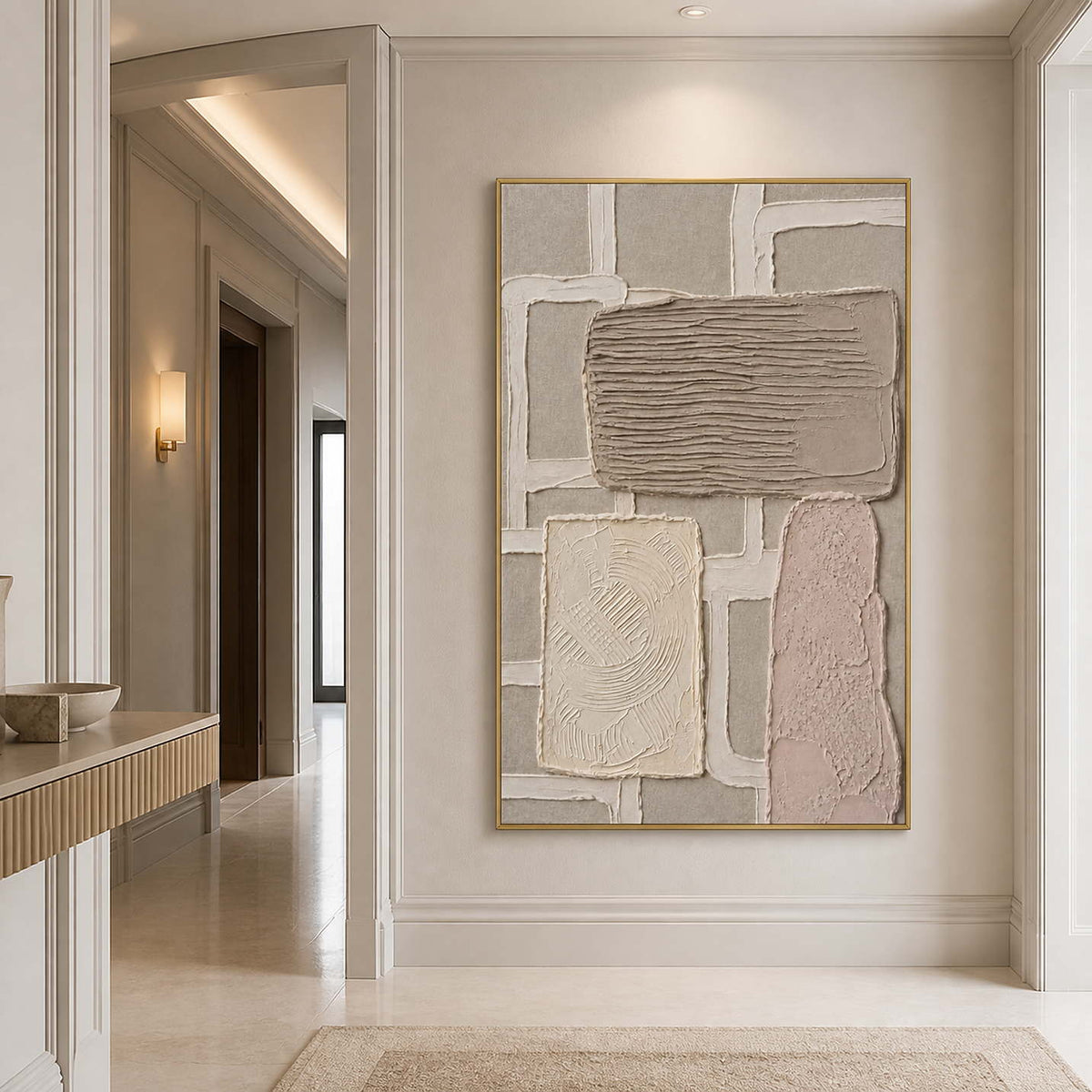 Textured neutral canvas in a gold frame styled in an entryway.