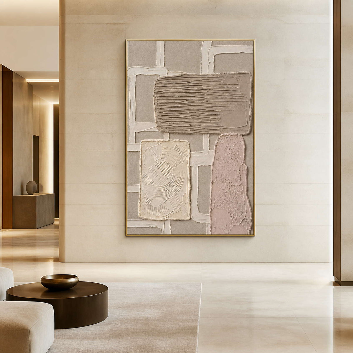 Minimalist neutral artwork in a gold frame inside a serene lobby.