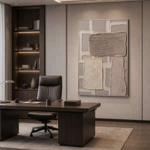 Vertical neutral artwork in a silver frame displayed in a modern office.