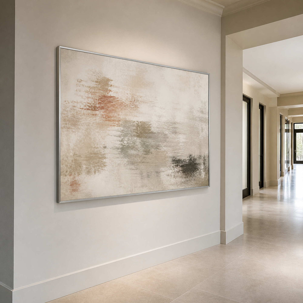 Textured neutral canvas in a silver frame styled in an entryway.
