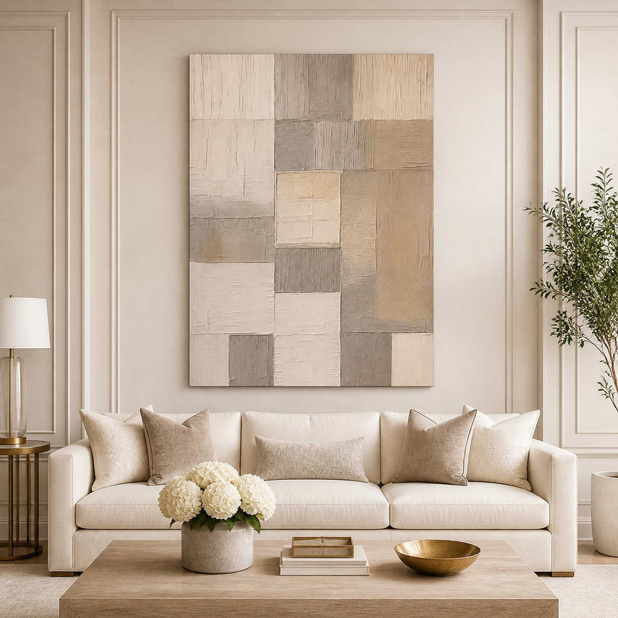Frameless cream and taupe geometric artwork above a light living room sofa.