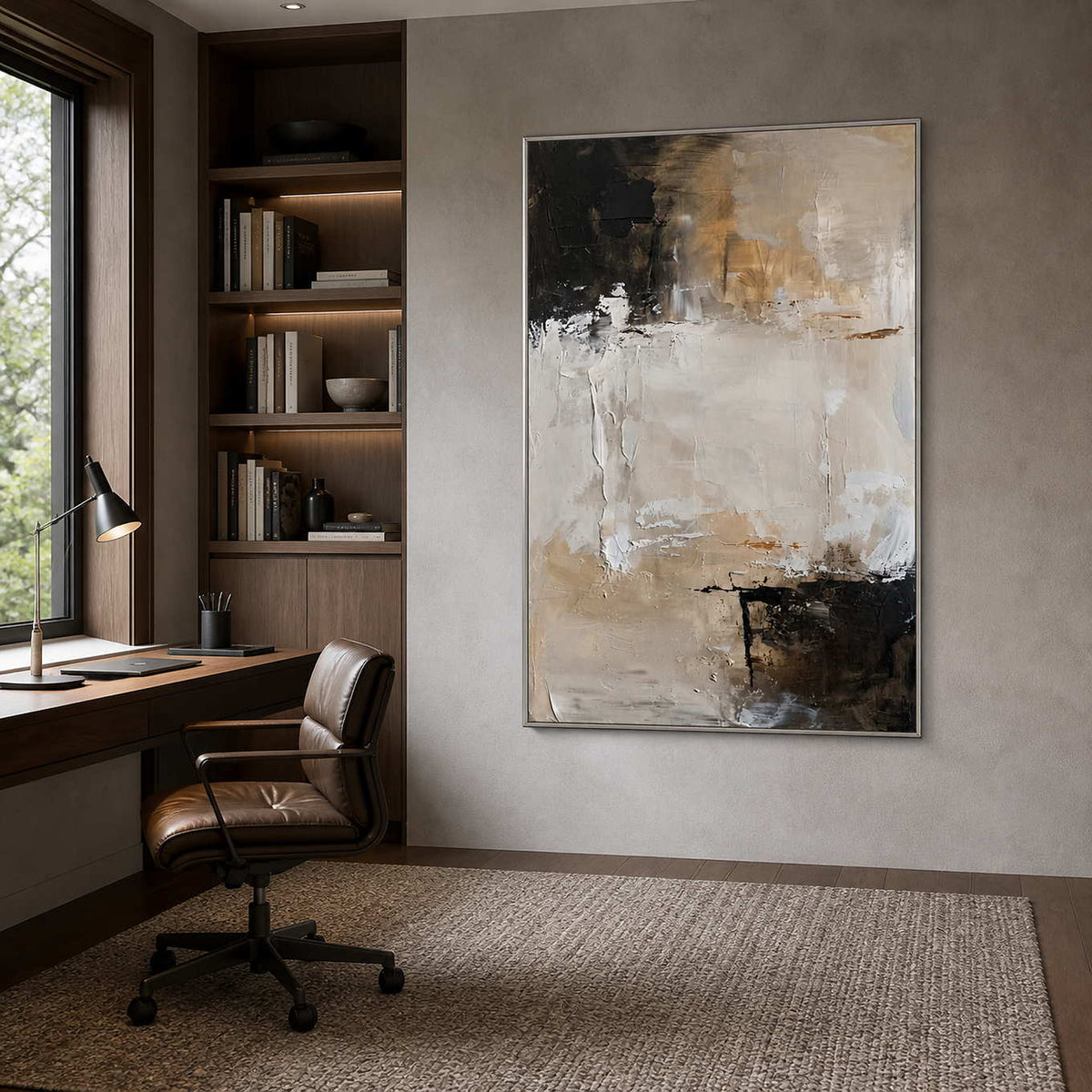 Silver framed neutral abstract painting beside a wooden desk in an office.