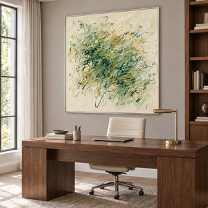 Spring Comes Calling in a silver frame above a large wood desk with a white office chair.