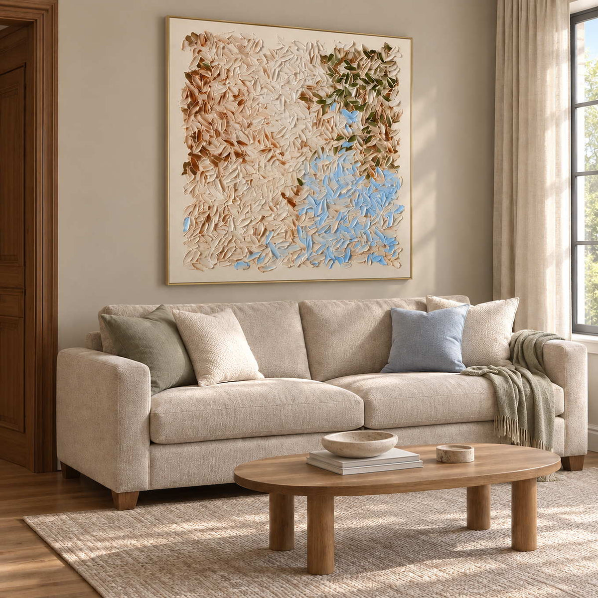 Spring Drifts In in a gold frame above a cream sofa with pale blue and muted green cushions.