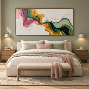 Pink and green abstract over a cream bed with muted pink throw and green cushions.