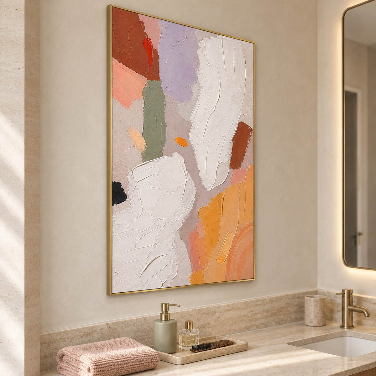 Abstract painting with ivory, lilac, sage, terracotta, and ochre forms in a gold frame beside a bathroom vanity.