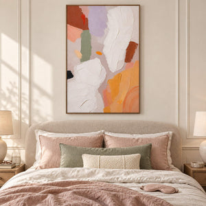 Abstract painting with ivory, lilac, sage, terracotta, and ochre forms in a brown wood frame in a bedroom.