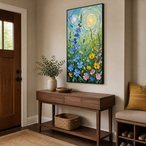 Black-framed blue and yellow flower painting above a wooden console beside the entrance door.