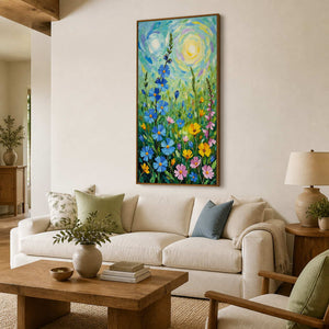 Tall floral painting in a wood frame above an ivory sofa with green pillows.