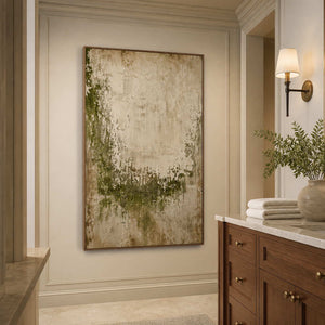 Wood framed textured green artwork beside a stone vanity in a neutral bathroom.
