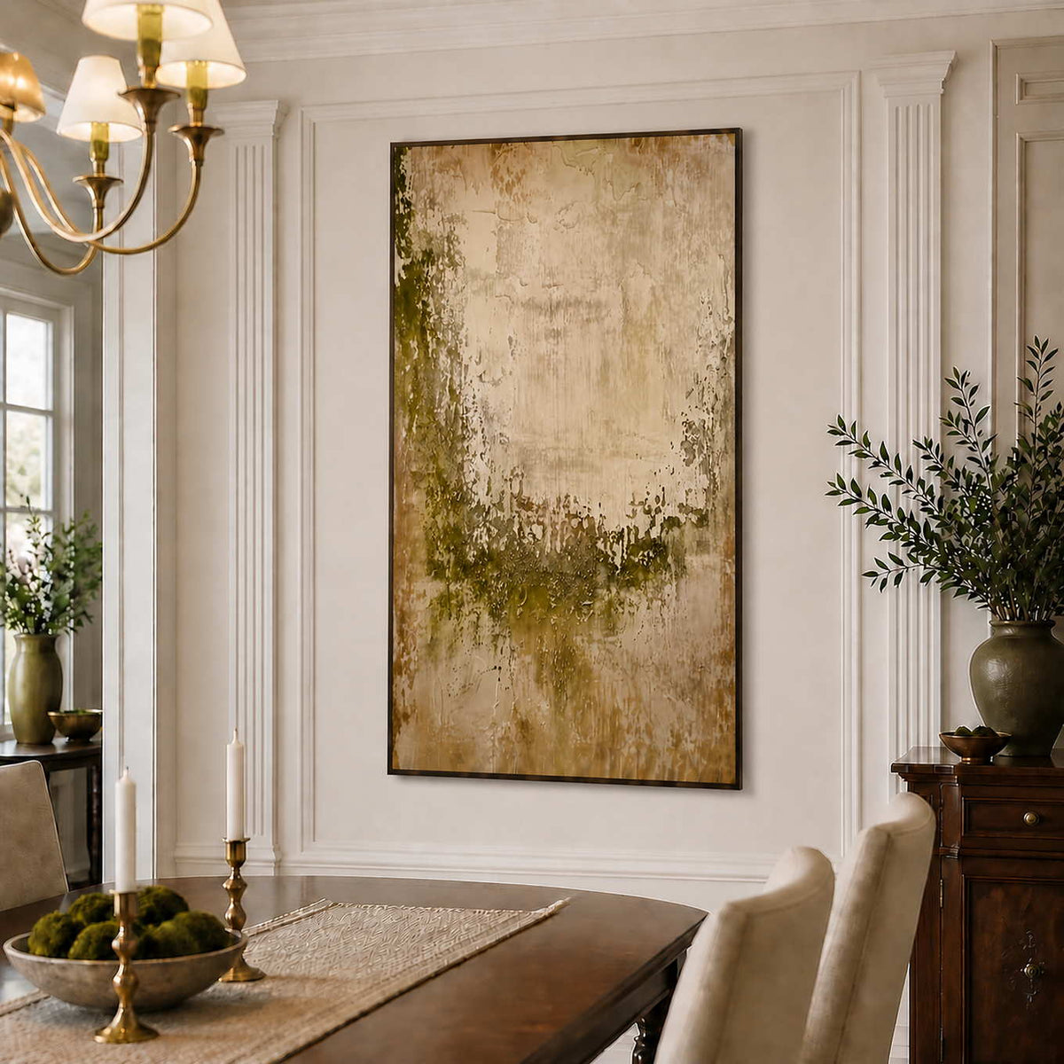 Black framed green and beige abstract painting beside a wooden dining table.