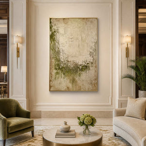 Gold framed green and beige abstract artwork above seating in a refined hotel lounge.