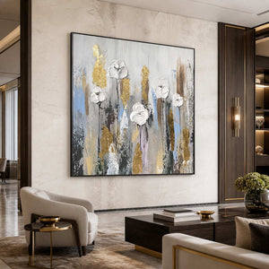 Black framed floral artwork behind cream hotel lobby seating and a dark wooden coffee table.