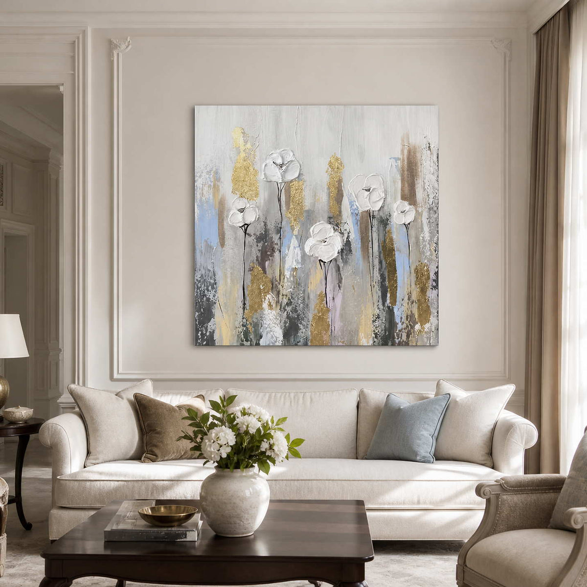Frameless white floral painting above a cream sofa with pale blue and neutral cushions.