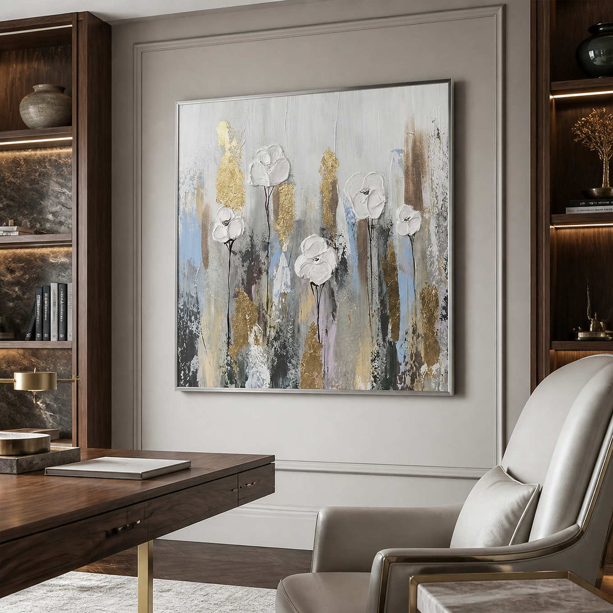 Silver framed white floral artwork beside a wooden desk and a cream office chair.