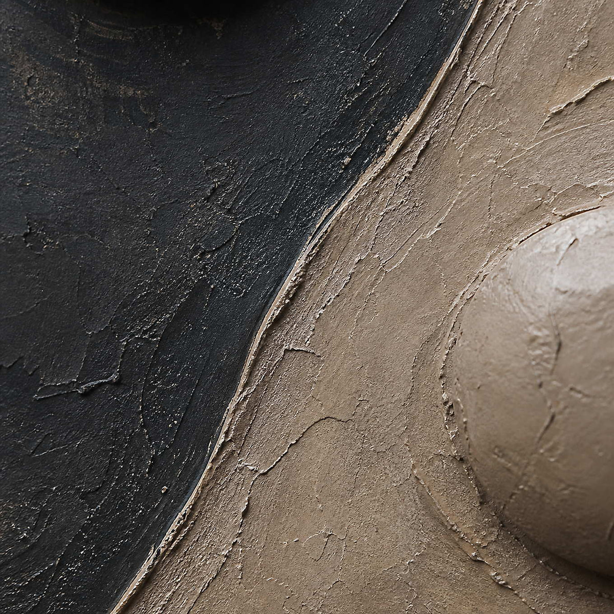 Close-up of charcoal, warm taupe, and rounded sculpted paint relief.