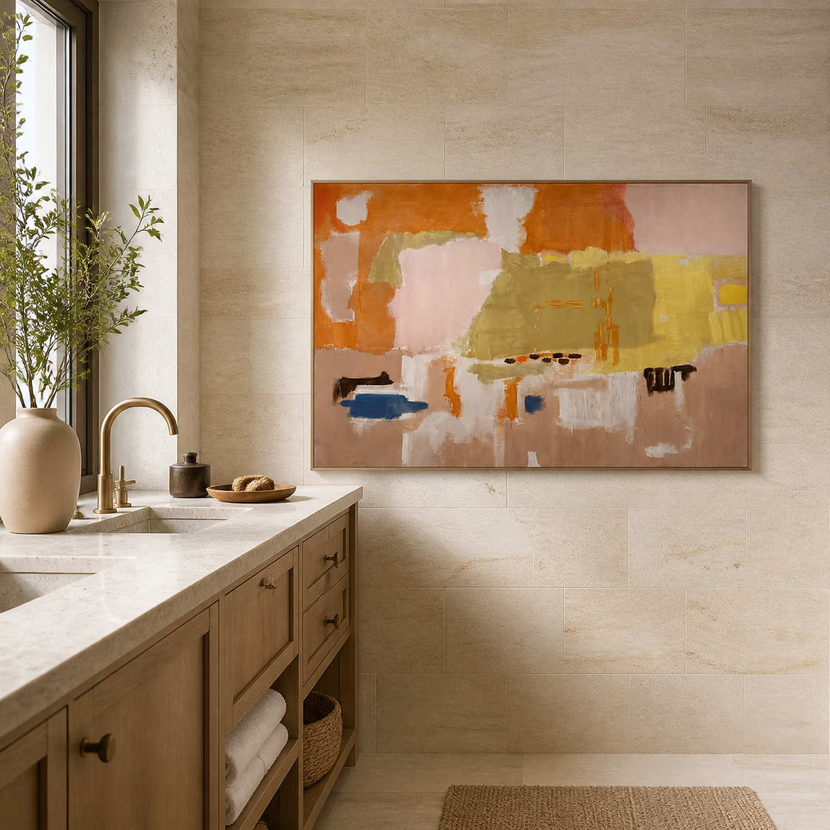 Wood framed warm abstract artwork beside a stone vanity in a bathroom dry area.