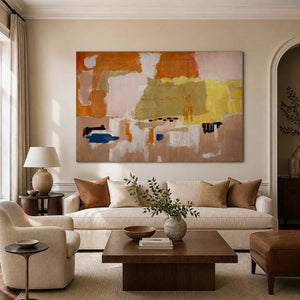Frameless orange and blush abstract artwork above a cream sofa in warm daylight.
