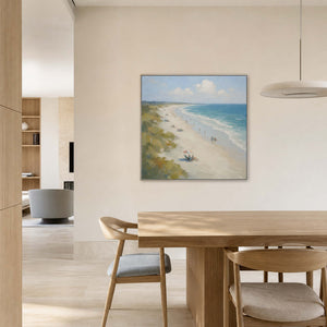 Square beach painting displayed in a warm white travertine dining room.