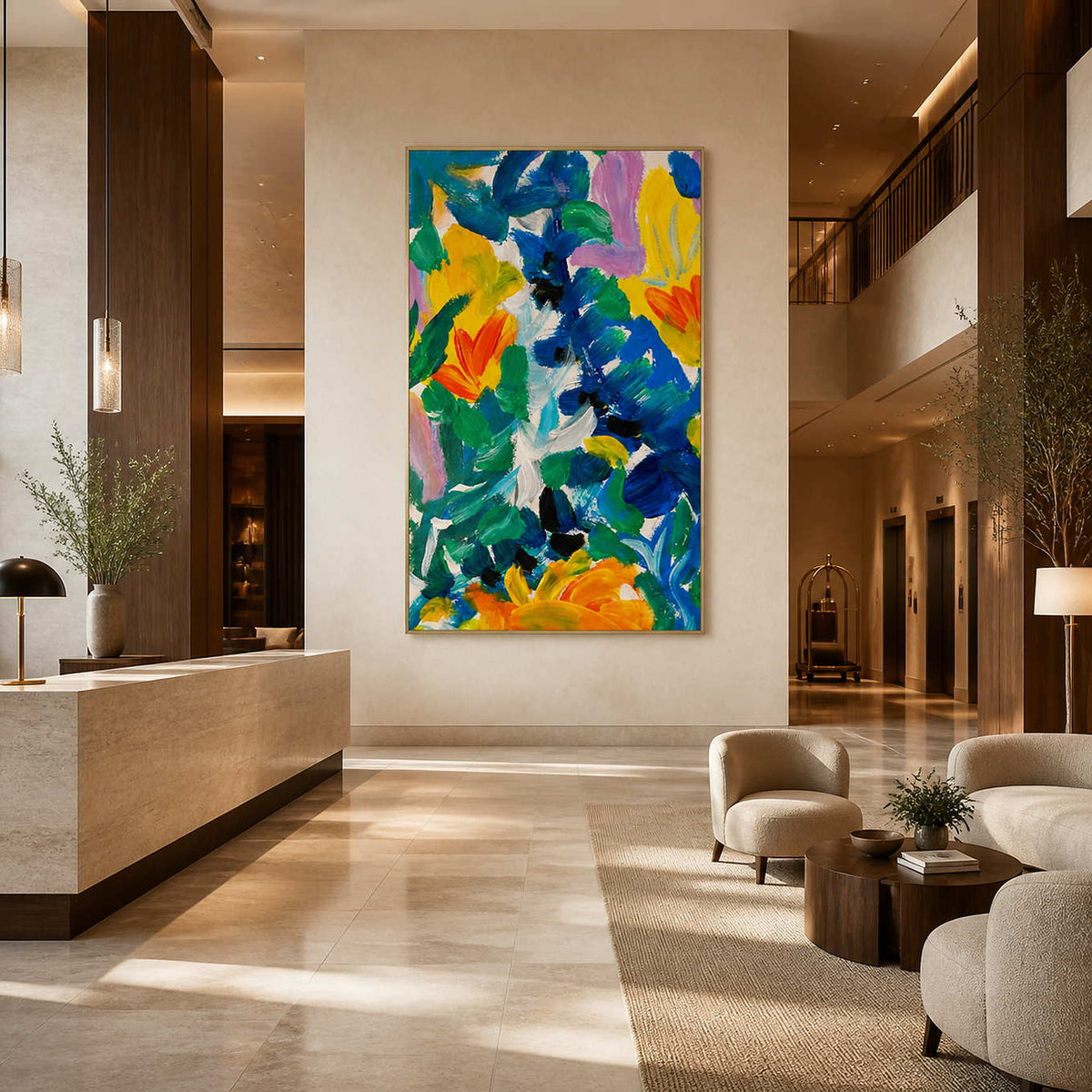 Gold framed summer floral artwork near a hotel reception desk, elevators, and cream lounge seating.