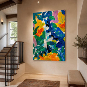Frameless colorful floral artwork hangs above a landing bench beside a sunlit residential staircase.