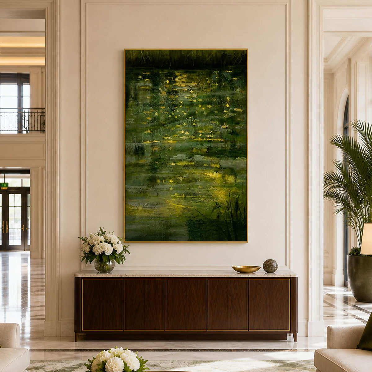 Gold framed waterside painting above a dark cabinet in a spacious hotel lobby.