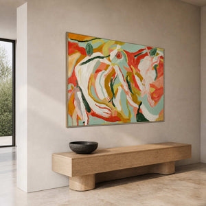 Summer Swirl in a silver frame above a long light wood bench in a stone-toned entryway, viewed from the side.