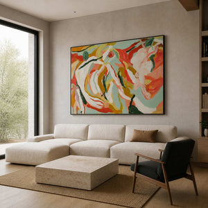 Summer Swirl in a black frame above a cream sofa, with flowing coral, yellow, green, and white petals brightening a modern living room.