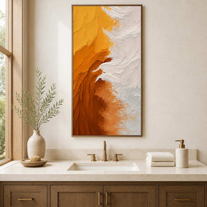 Wood framed yellow and white artwork above a vanity in a bathroom dry area.