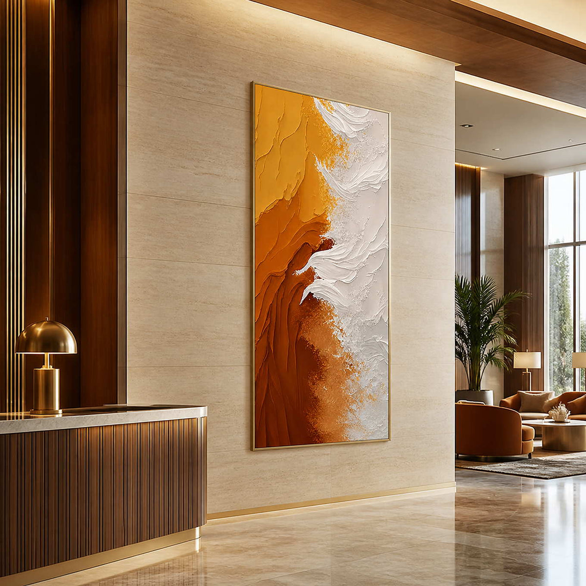 Gold framed amber and white artwork beside a hotel reception desk and lounge seating.