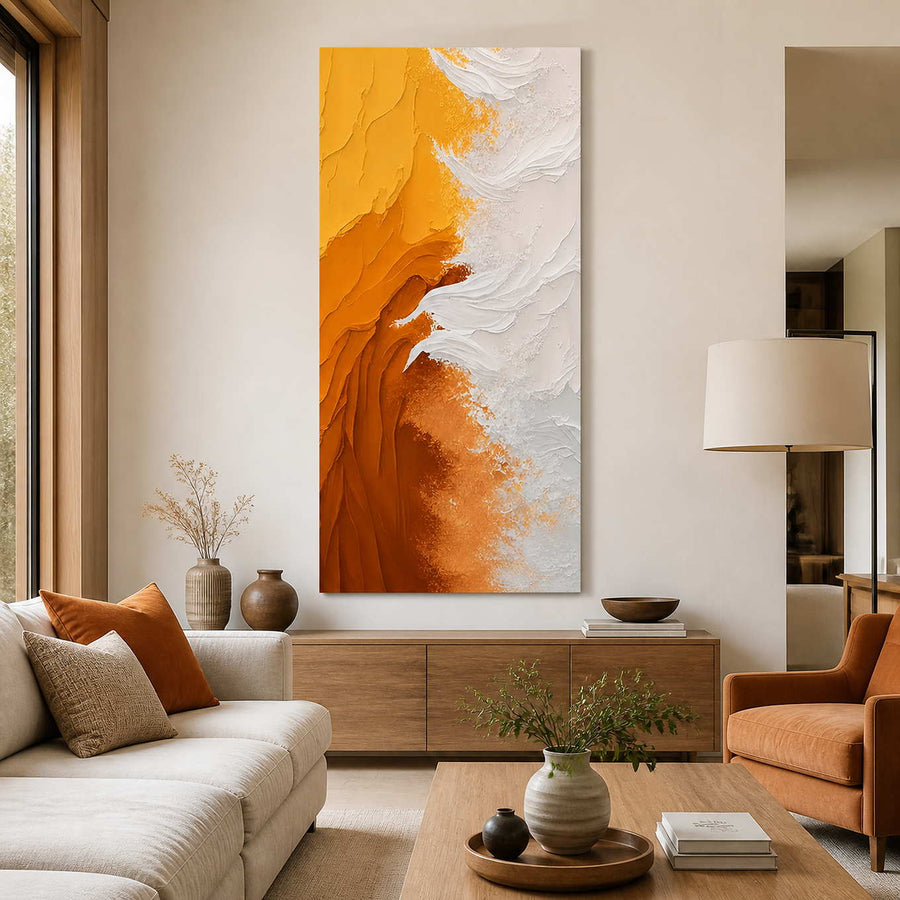 Frameless yellow and white artwork above a wooden cabinet in a sunlit living room.