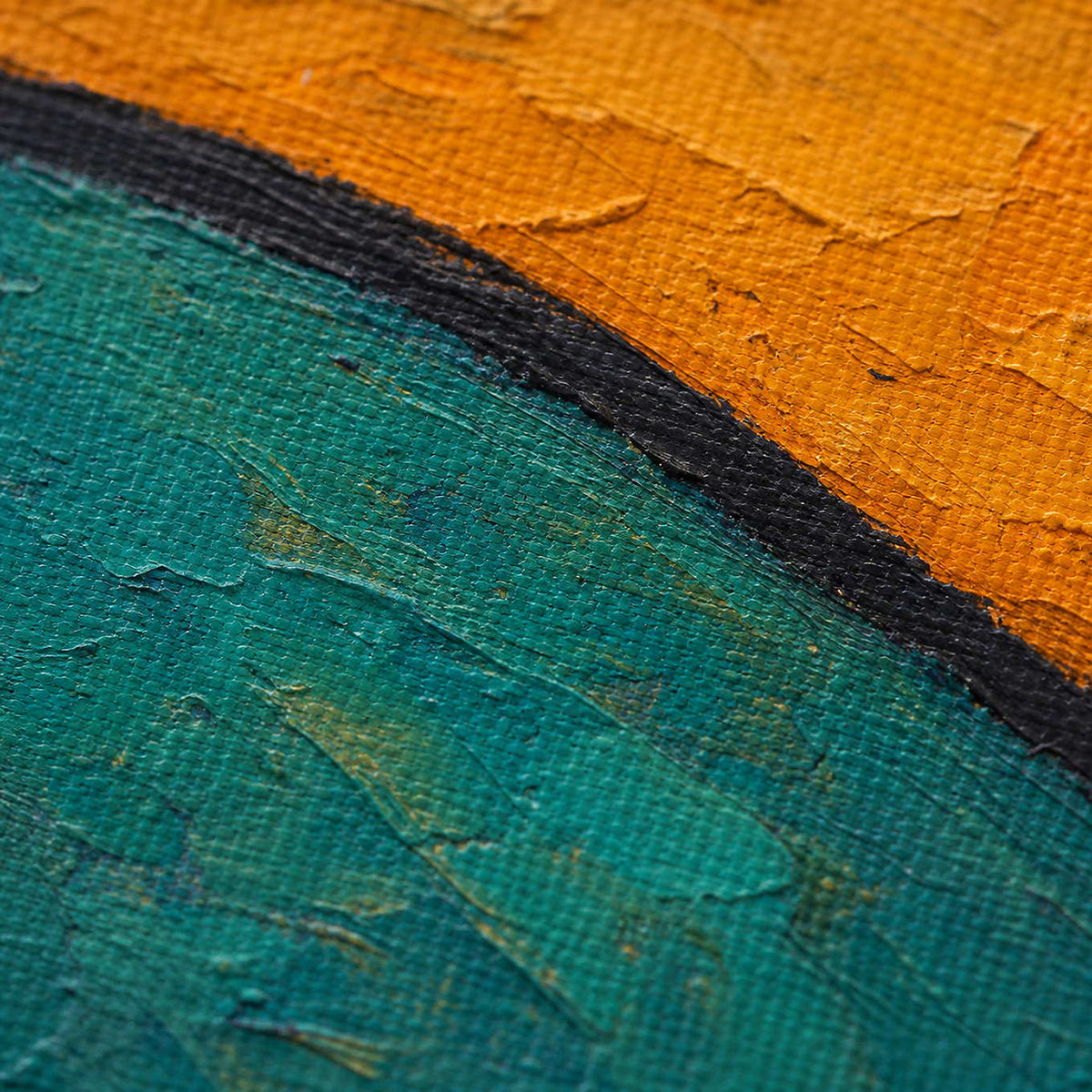 Close-up of turquoise and amber paint divided by dark graphic lines.