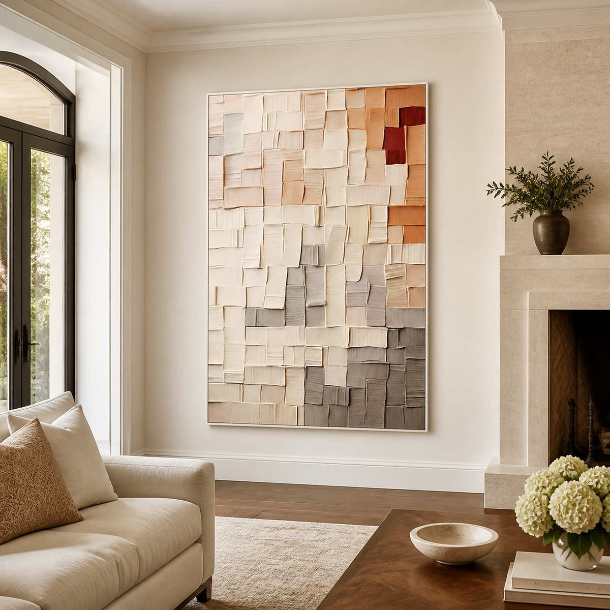 White-framed textured abstract wall art between a cream sofa and fireplace in a living room.