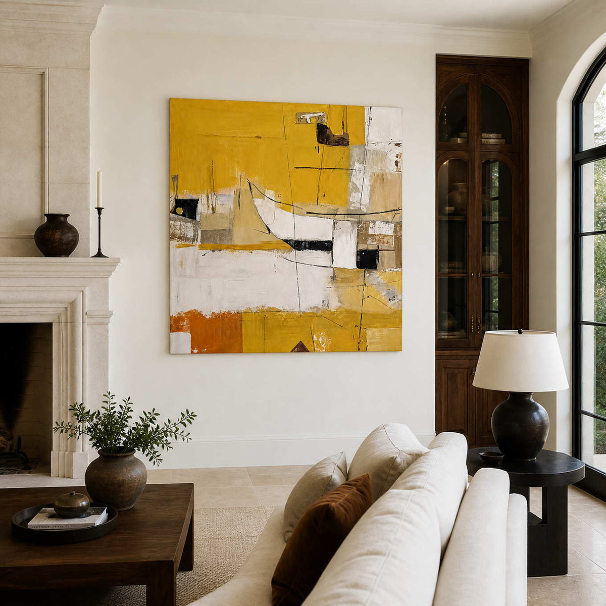 Frameless yellow and cream abstract artwork beside a fireplace above a neutral living room sofa.