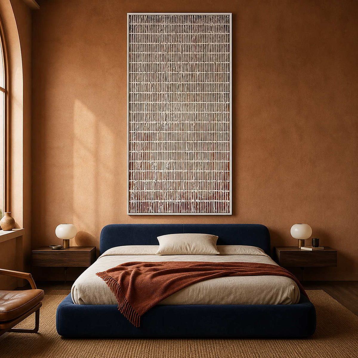 White framed narrow lattice painting above a blue upholstered bed.