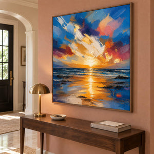 Square textured seascape in cobalt blue coral and molten gold, displayed in an entrance hall in a brown wood frame.