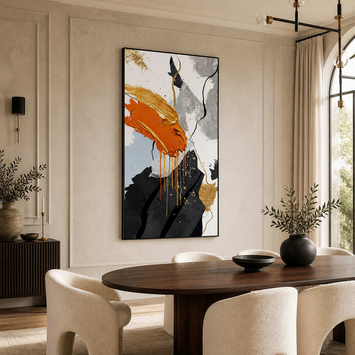 Black-framed orange abstract painting beside an oval wooden dining table and cream chairs.