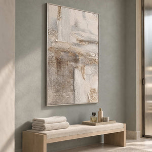 Pale textured artwork above a bench with folded towels and a small toiletry tray.