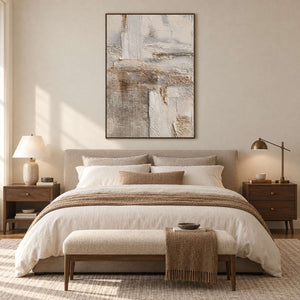 Pale patchwork-like abstract above a beige bed with brown throw and matching bench.