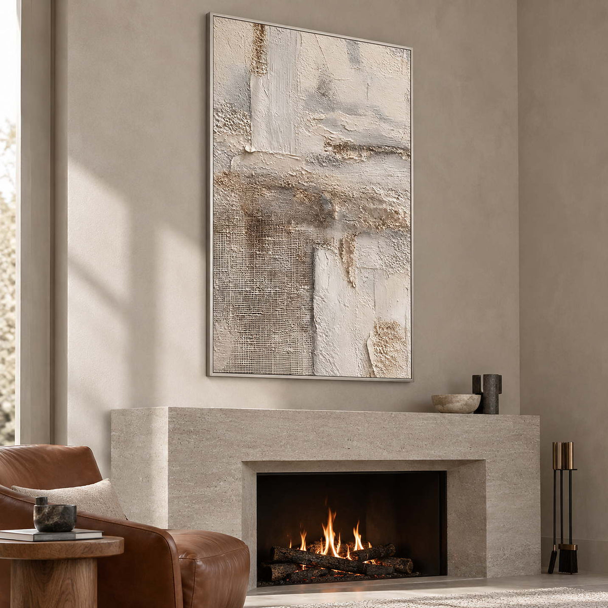 Neutral vertical abstract above a lit gray-beige fireplace beside a brown chair.