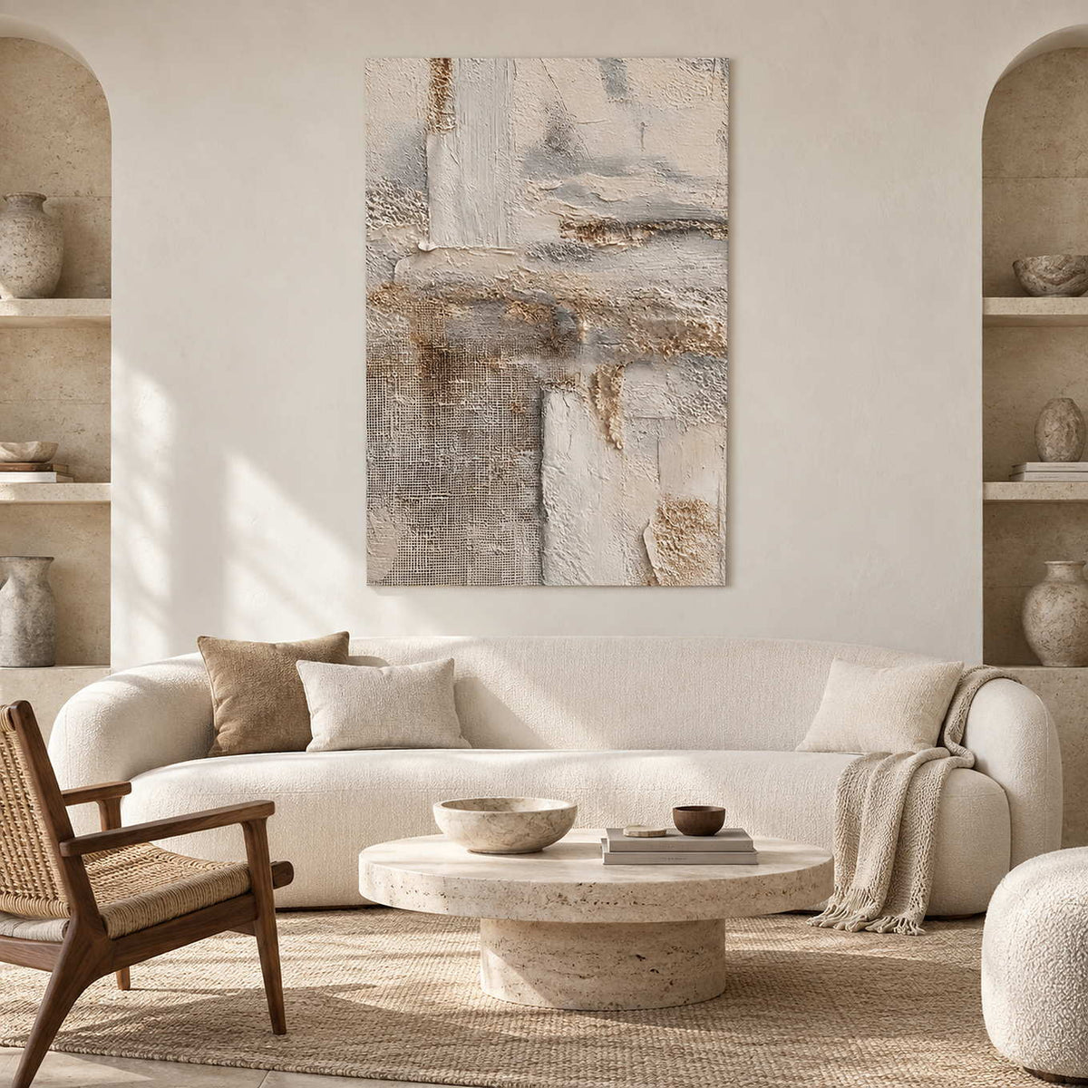 Pale textured abstract above a cream sofa between recessed display shelves.