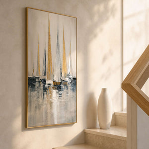 Narrow coastal wall art displayed beside a bright wood stairway.