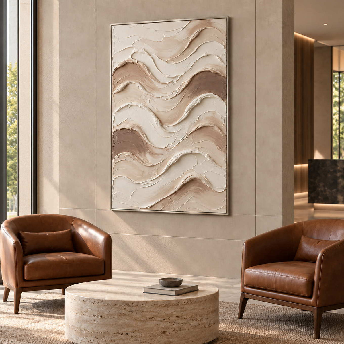 Tenderness in a silver frame above two brown leather armchairs and a round stone table in a commercial lobby.