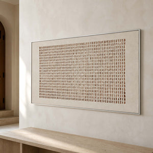 Raised geometric wall art viewed close-up in a quiet entryway gallery.