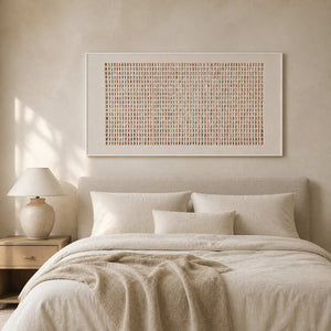 Ivory and terracotta abstract wall art displayed in a quiet white bedroom.