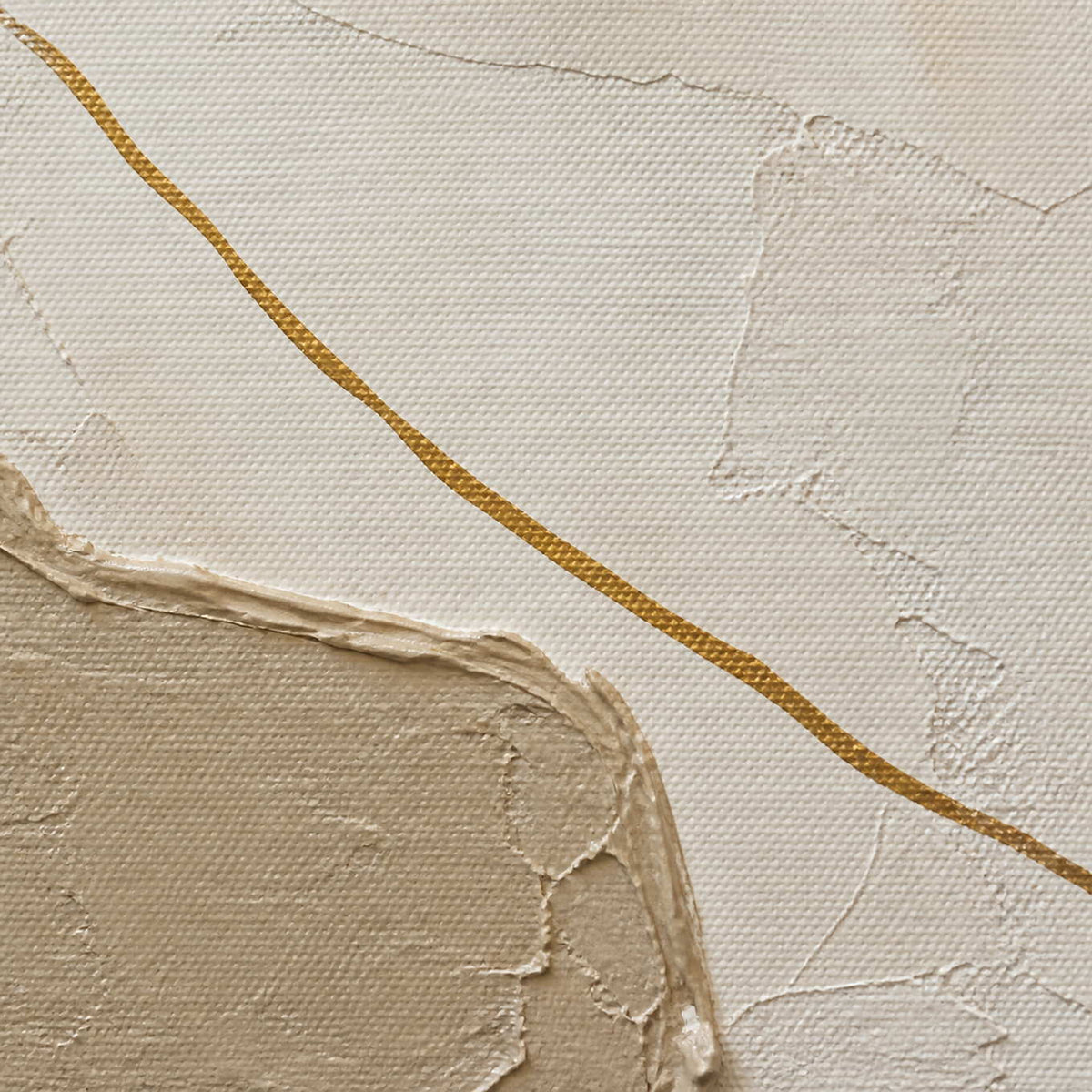 Close-up of layered taupe plaster and a fine metallic gold line.